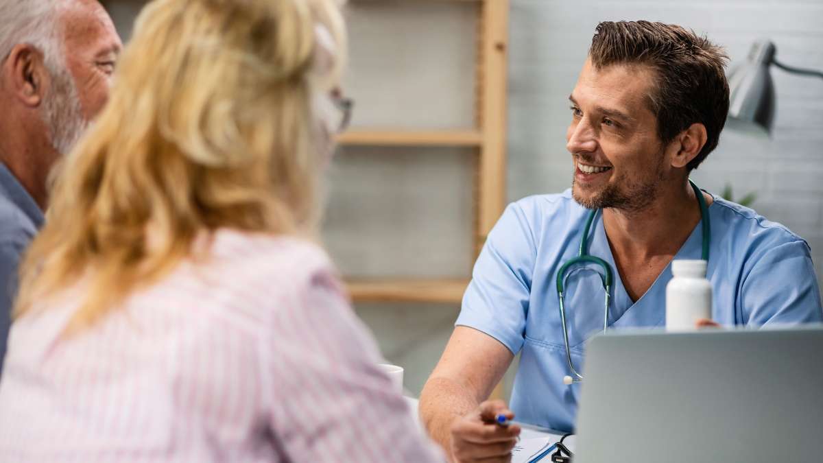 Elderly couple facing alcohol-related issues talking to a medical staff about the common medications used in alcohol detox.