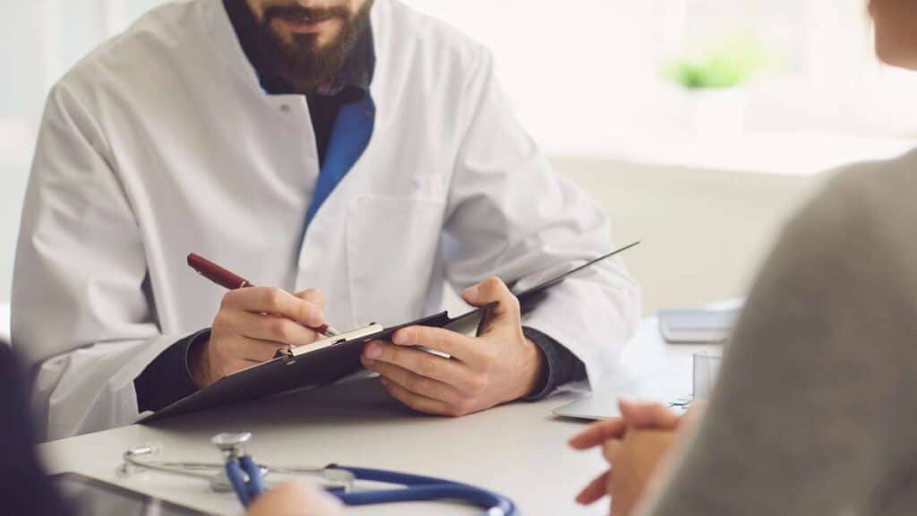 Medical professional advising patient on medication-assisted heroin detox during consultation.